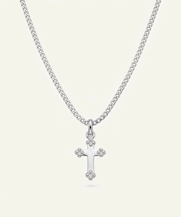 Close-up of silver cross pendant