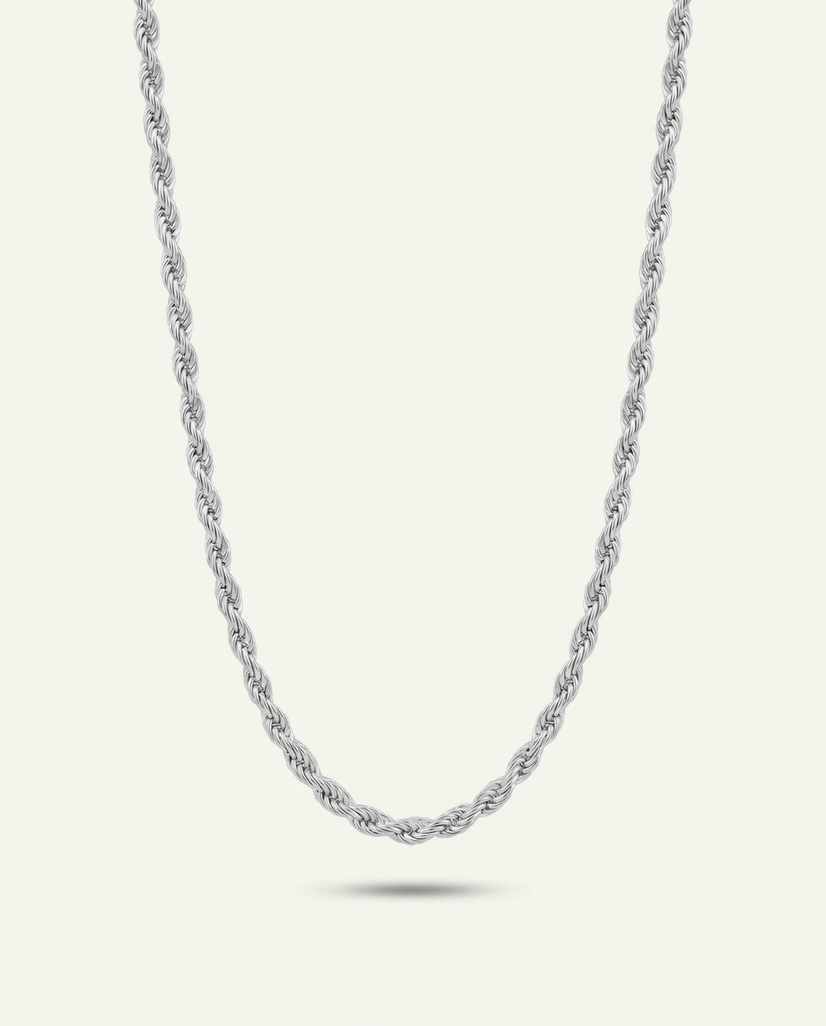 A silver twisted rope chain necklace shown against a light cream background with a soft shadow underneath.