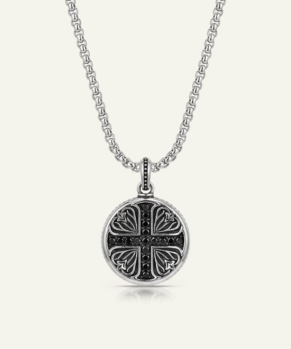 Close-up of black cubic zirconia cross medallion