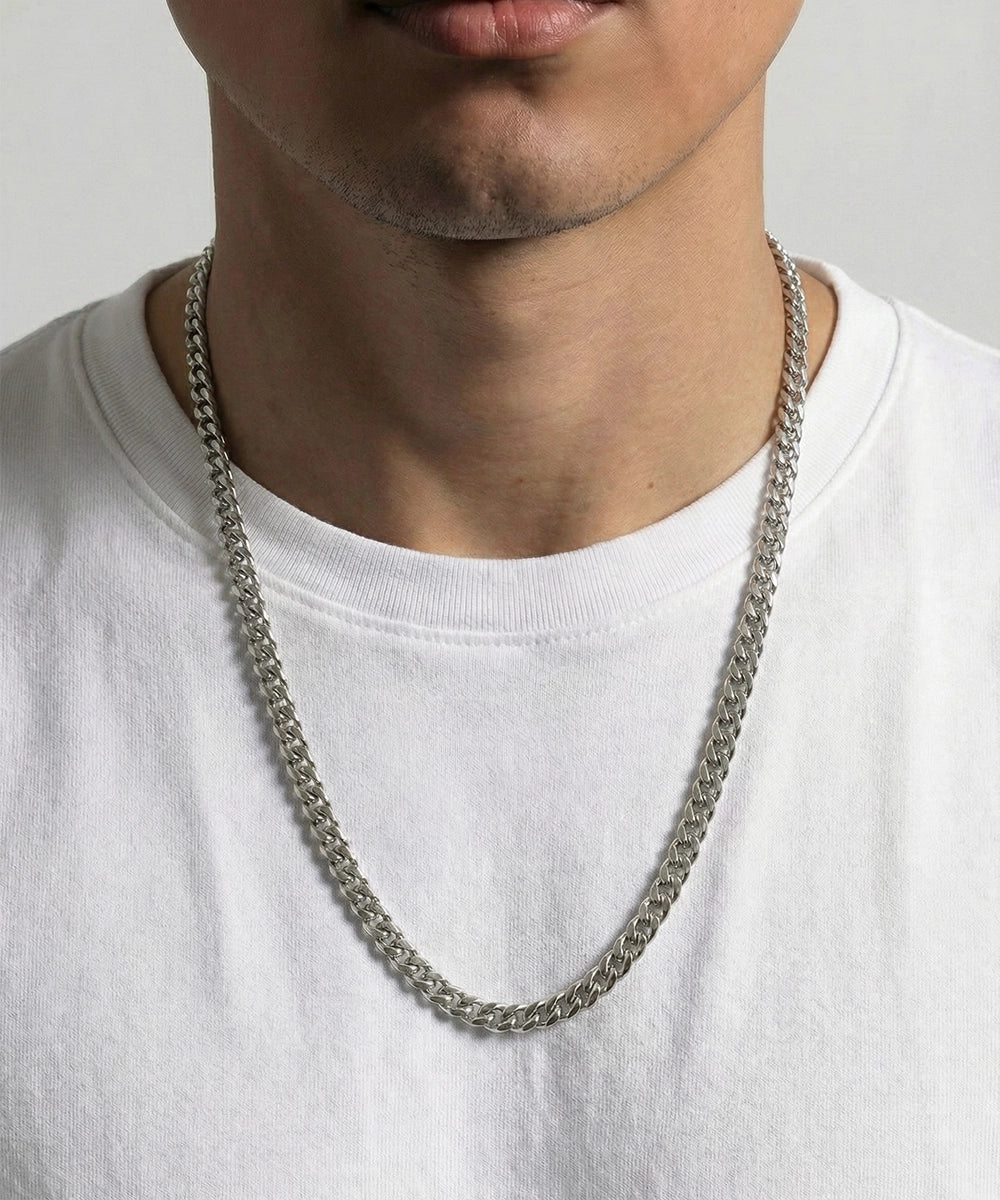 men's 24-inch silver-toned Cuban chain necklace on model wearing white t-shirt