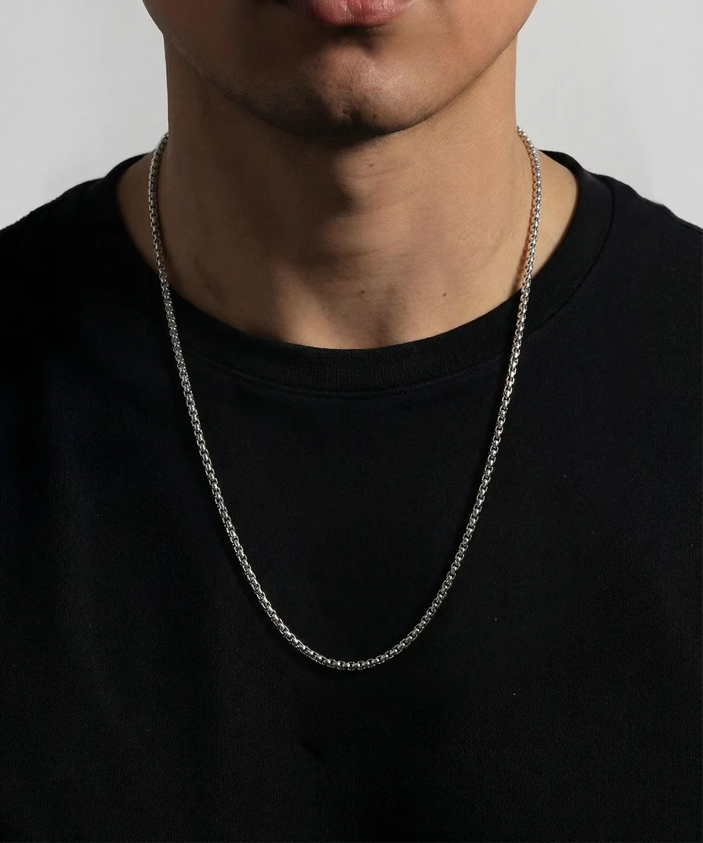 men's silver-toned stainless steel box chain necklace on model wearing black t-shirt