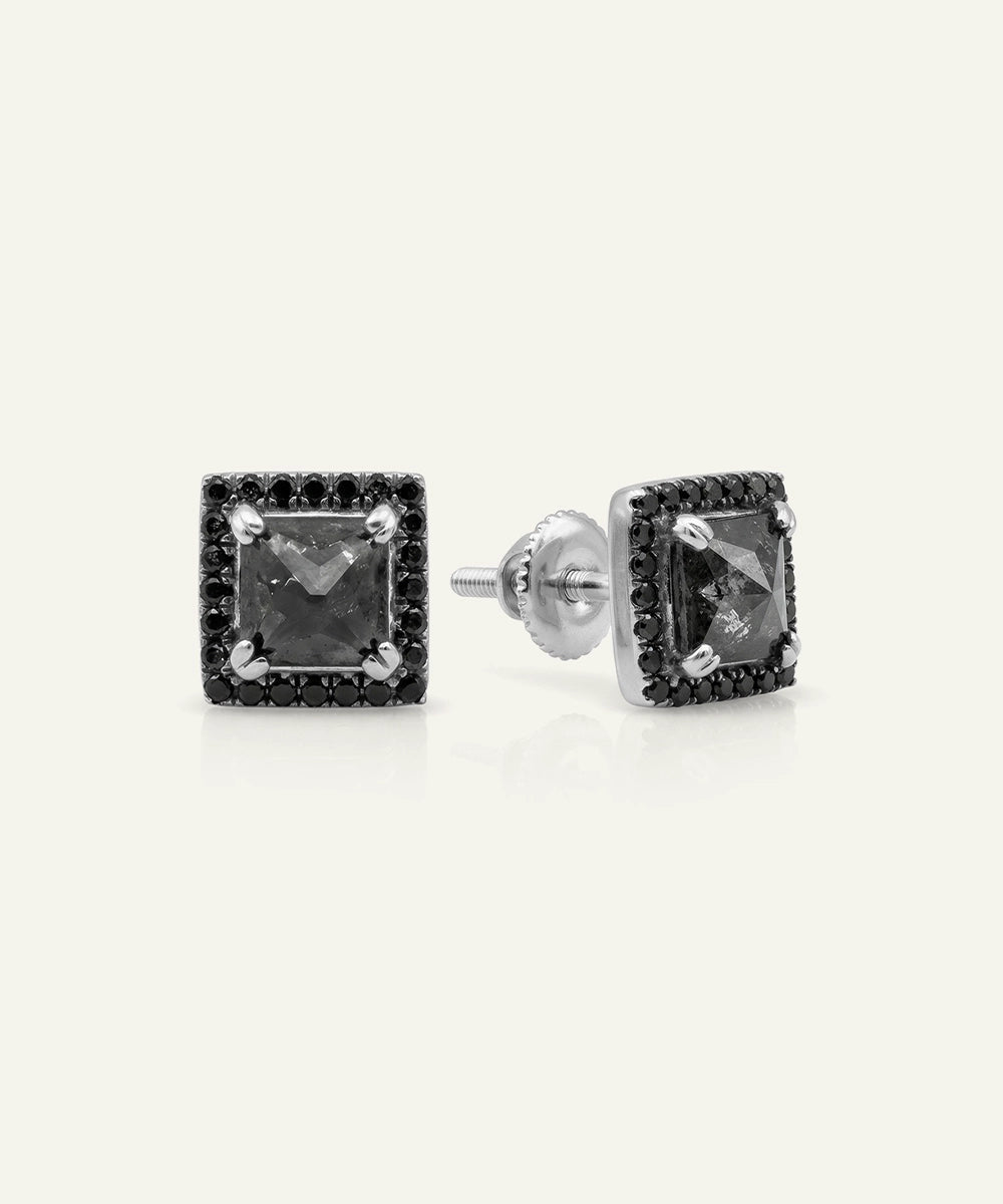 Close-up of men's princess-cut black diamond halo studs in silver finish