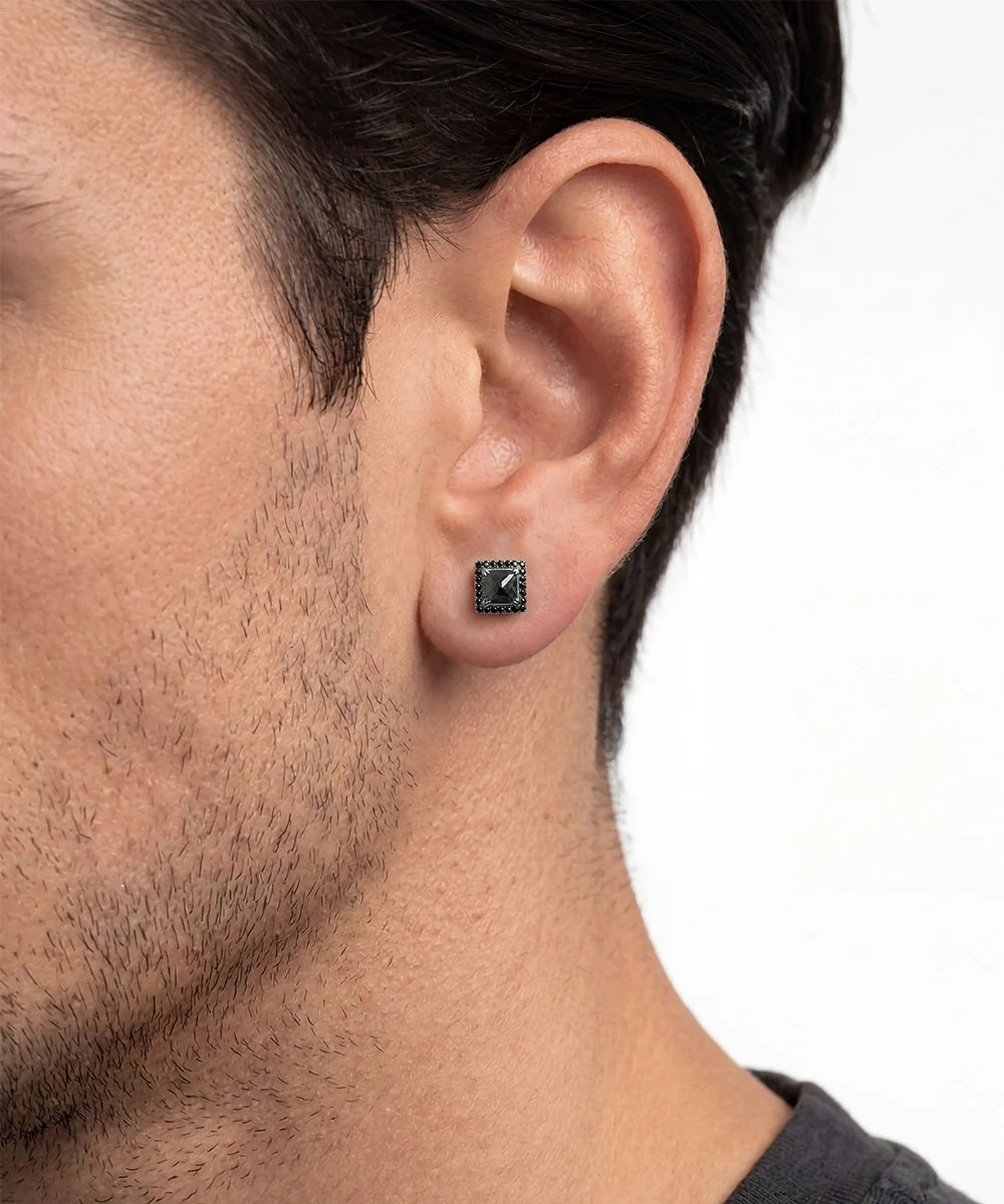 Front view of men's black diamond halo stud earrings in silver finish