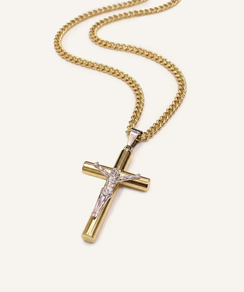 Gold cross pendant necklace on a white background