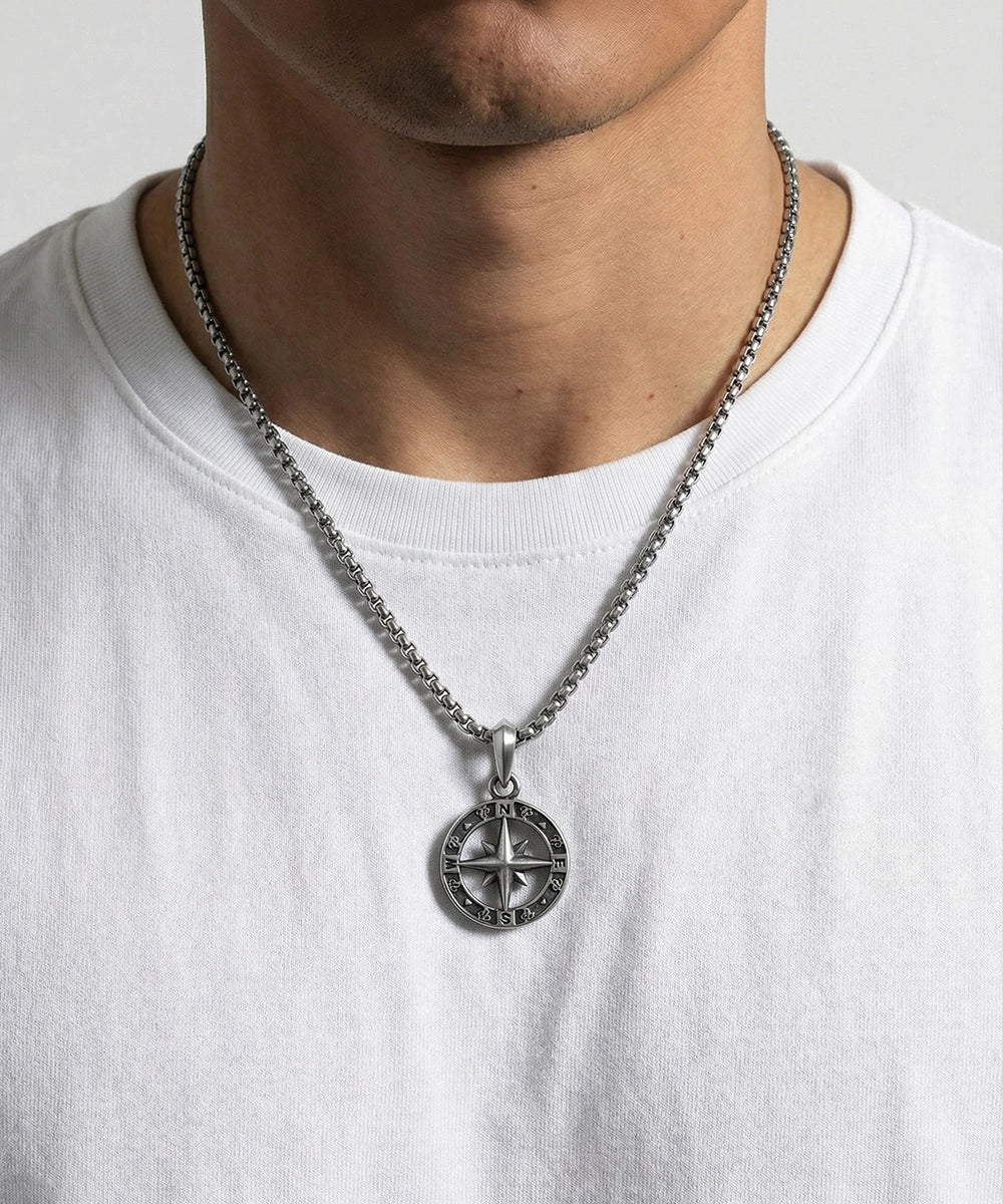 Close-up of compass pendant