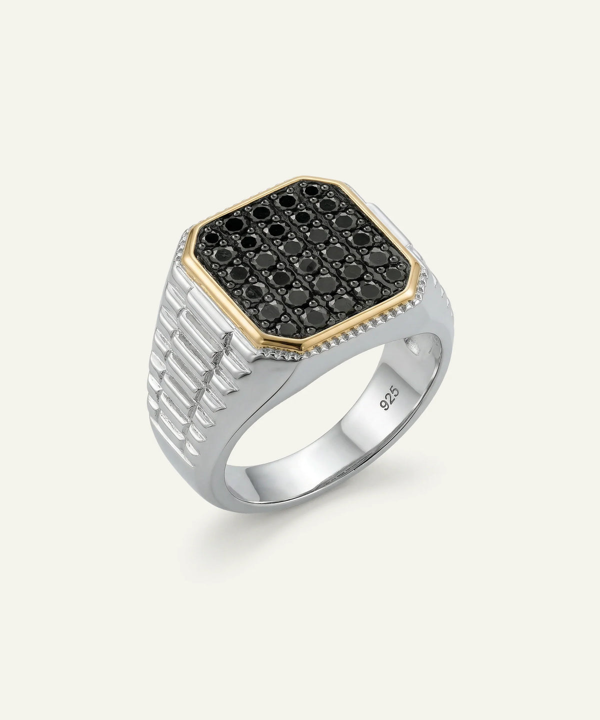 A men's signet ring featuring a silver-toned band with a textured channel-set side and a bezel-set top. The top is paved with small black round stones and framed by a gold-tone border, with a row of tiny clear stones along the front edge.