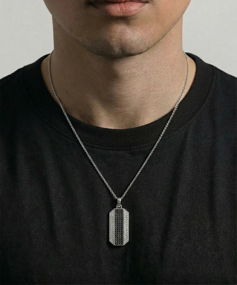 Close-up of diamond dog tag pendant